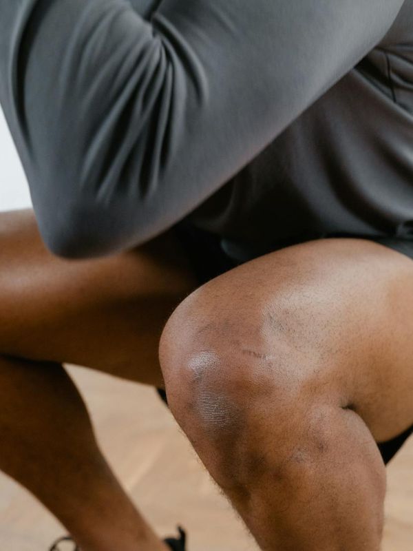 Man performing a stability exercise on one leg.