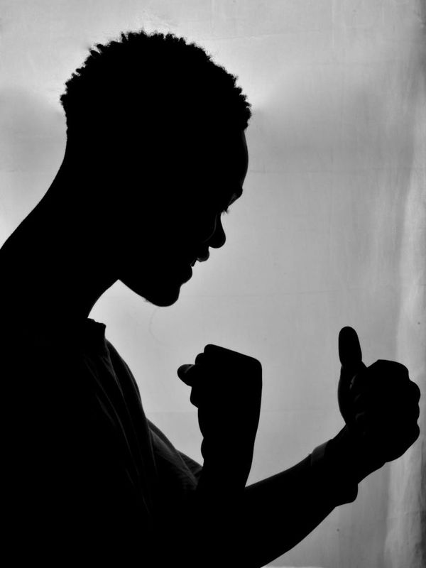 Silhouette of a man in a powerful, grounded stance.